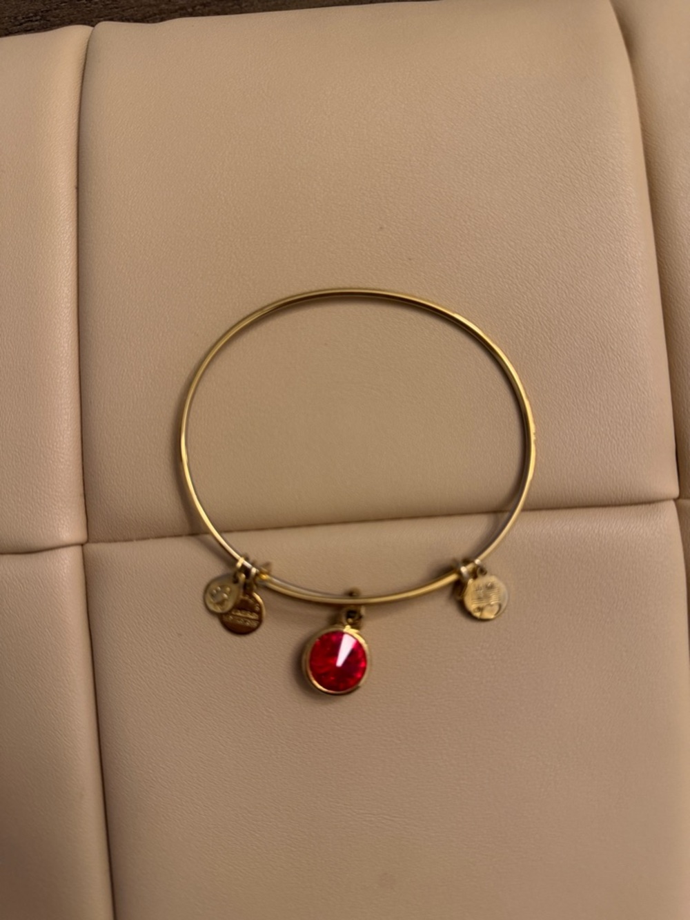 Gold Tone Bangle Bracelet with Red Crystal Charm